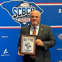 Retired Laurens Raiders head baseball coach Ed Prescott with his SCBCA Hall of Fame plaque at last week's induction ceremony.